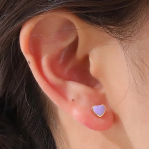 Close-up of a model wearing the purple enamel heart earring with a golden metal base