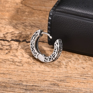 Detailed view of retro patterned stainless steel hoop earring for men with tribal engraving
