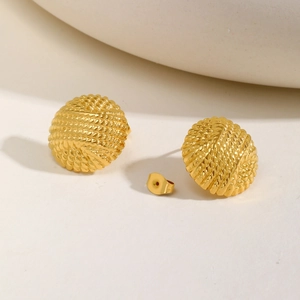 Detailed macro view of gold embossed round stud earrings with woven rope texture