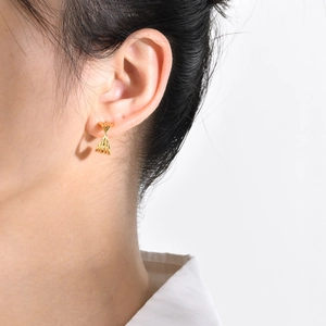 Elegant gold twisted hoop earrings with textured finish shown on a model