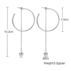 Detail view of long silver tassel earrings with 10.2cm length and geometric circle design