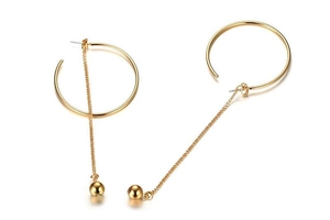 Detailed view of long gold tassel earrings featuring geometric circles and hanging chains