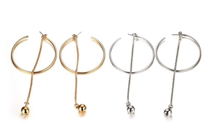 Detailed view of long tassel hoop earrings with metal beads in gold and silver finish