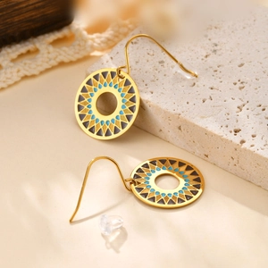 Detail of 18K gold-plated earrings with blue enamel geometric pattern on stone base