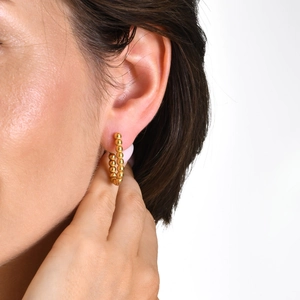 Classic 18K gold plated stainless steel beaded hoop earrings for women on a model