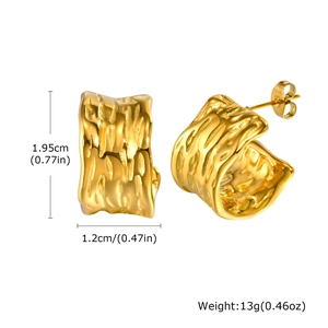 Detailed size view of chunky textured 18K gold C-shaped earrings with wave patterns