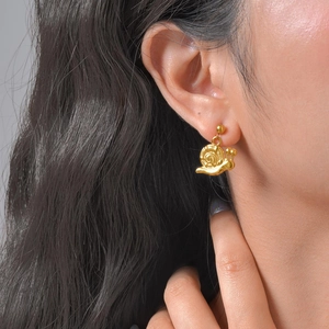 Fashionable 18K gold plated stainless steel snail earrings for women on model ear