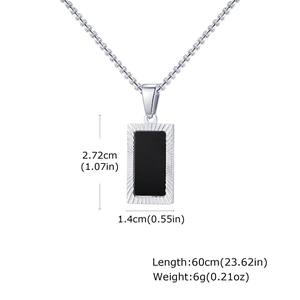 Macro detail of men's geometric black acrylic pendant with engraved silver border