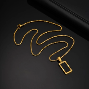 Detailed view of men's gold stainless steel necklace with black rectangular inlay pendant
