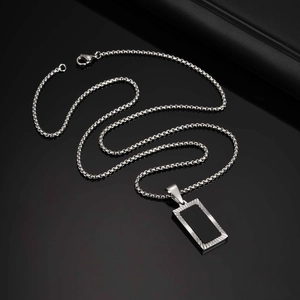 Detail of square black acrylic pendant with textured silver border and box chain