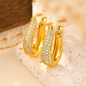 Elegant 18K gold plated U-shaped hoop earrings with pave cubic zirconia on stone background