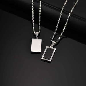 Detail of silver box chain with solid and textured hollow rectangular pendants