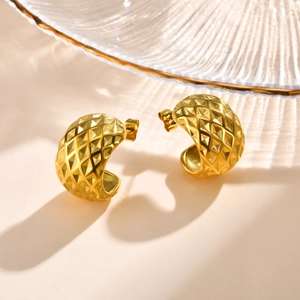Macro detail of 18K gold-plated C-shape earrings with vintage embossed rhombus pattern