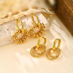 Golden multi-layered beaded hoop earrings for women on a textured stone aesthetic background