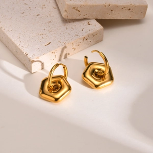 Detailed view of chunky gold geometric pentagon hoop earrings with polished finish