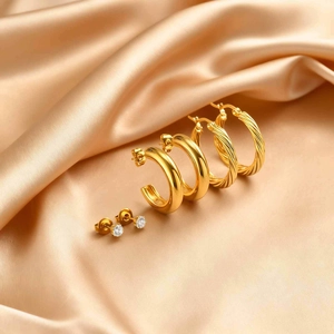 Three-piece gold earring set featuring zircon studs, chunky C-hoops and twisted rope hoops