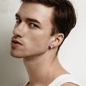 Stainless steel hoop earring with colorful transgender flag stripes on model