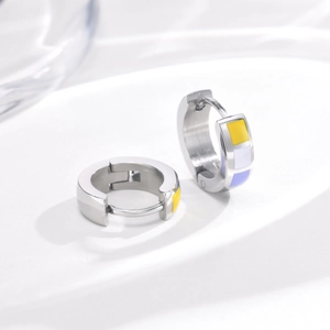 Macro shot of stainless steel earrings with colorful enamel patterns and snap closure