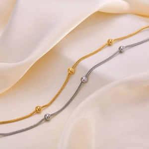 Elegant gold and silver stainless steel snake chain anklets with beads on silk fabric