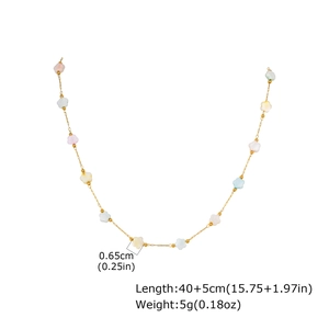 Detail of colorful macaron flower charms on a gold stainless steel chain necklace