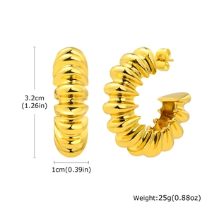 Detail view of gold C-shaped chunky earrings with twisted croissant texture and size specs