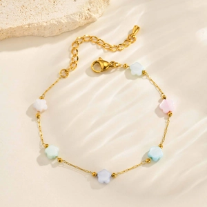 Detail of gold flower bracelet with colorful resin petals and adjustable lobster clasp
