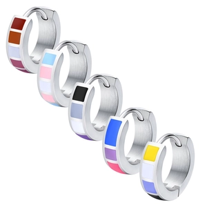 Five stainless steel hoop earrings with colorful enamel flag patterns on white background