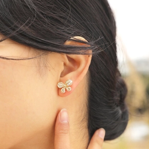 Elegant butterfly stud earring with shimmering cubic zirconia on golden metal base