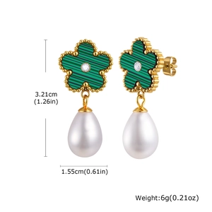 Detail view of flower pearl earrings with emerald green inlay and size measurements