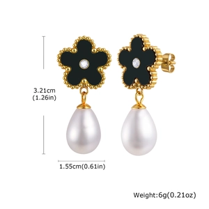 Detail view of flower earrings with black petals, crystal center and white drop pearls