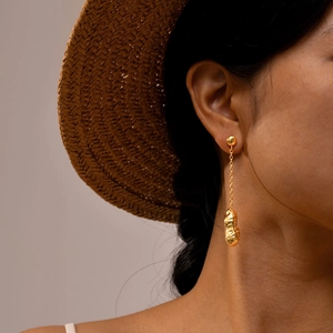 Fashionable 18K gold-plated stainless steel peanut tassel earrings worn by a model