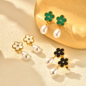 Detailed set of three floral pearl drop earrings in green, black, and white finishes