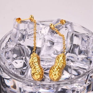 Fashionable 18K gold stainless steel peanut tassel earrings shown over ice cubes