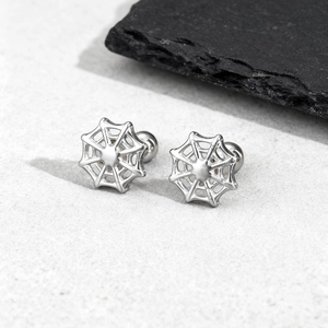 Macro detail of silver stainless steel spider web stud earrings with screw ball backs
