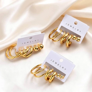 Three-set gold stainless steel hoop earrings and ball studs on a jewelry display card