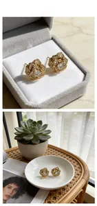 Detailed close-up of rotating rose stud earrings with pavé crystals in gold setting
