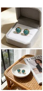 Detailed view of turquoise stud earrings with gold rim in a velvet jewelry box