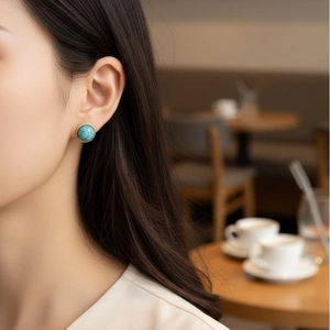 Vintage round turquoise earrings with gold bezel on model for an elegant retro look