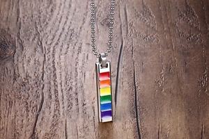 Macro view of rainbow enamel rectangle pendant on stainless steel ball chain necklace