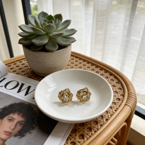 Rotating rose flower earrings with gold finish and white crystals in a vintage design
