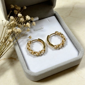 Elegant Mobius wrap hoop earrings featuring small white pearls and golden metallic finish