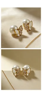 Detail of butterfly stud earrings with mother-of-pearl, crystals and large white pearls