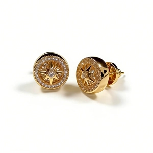 Gold starburst compass earrings with pavé crystals and polished vintage finish
