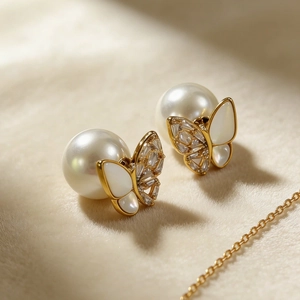Elegant mother of pearl butterfly earrings with gold plating and white round pearls