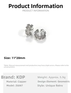 Macro detail of silver-tone C-shape hoop earrings with irregular pavé cubic zirconia