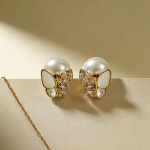 Elegant gold butterfly pearl earrings with shimmering crystals and mother-of-pearl