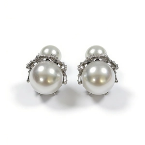 Detail view of elegant double-sided pearl earrings with silver crown and rhinestones