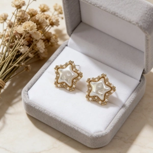 Vintage gold-plated star earrings with pearls and crystals in a velvet jewelry box