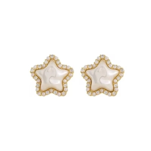 Elegant star-shaped stud earrings in gold with white mother-of-pearl and crystal details