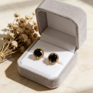 Boucles d'oreilles rondes dorées avec pierre noire et halo de diamants scintillants